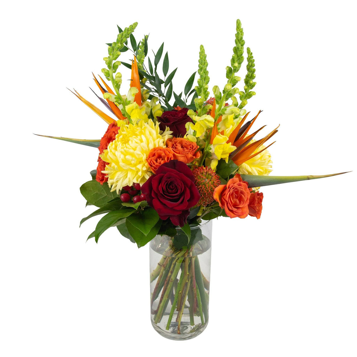 Vase arrangement of tropical and temperate fresh flowers including yellow daisies, orange roses, red gerbera daisies, and green foliage